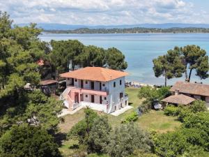 an aerial view of a house and the water at Studios Efi beach in Vourvourou