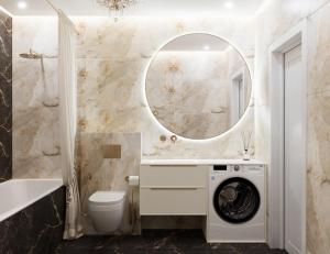 a bathroom with a washing machine under a mirror at Lutsk Elegance Apartment in Lutsk +16 photos