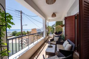 a balcony with chairs and a view of the ocean at Auster House Santorini in Kamari