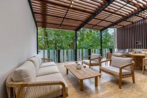 a living room with a couch and chairs and a table at Capitalia Temistocles Polanco in Mexico City