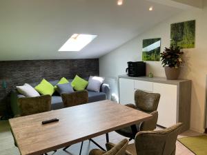 a living room with a couch and a table and chairs at Ferienwohnung Sevim in Lermoos