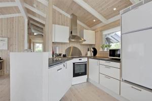 a kitchen with white appliances and a wooden ceiling at 30078-Malling-Peter-Eriksensvej-21 in Malling