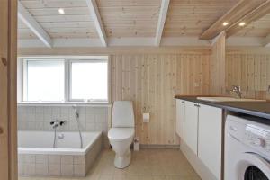 a bathroom with a toilet and a tub and a sink at 30078-Malling-Peter-Eriksensvej-21 in Malling +15 photos