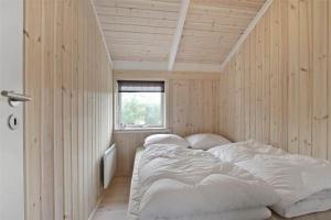 a bedroom with two beds in a room with wooden walls at 30078-Malling-Peter-Eriksensvej-21 in Malling