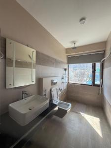 a bathroom with a sink and a toilet at Bön Valley in Jomsom