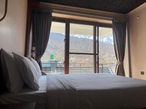 a bedroom with a bed with a view of a mountain at Bön Valley in Jomsom