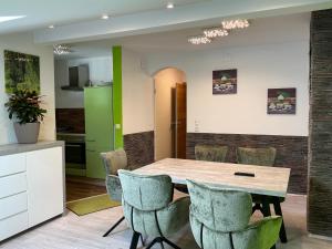 a kitchen and dining room with a table and chairs at Ferienwohnung Sevim in Lermoos