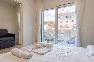 a bedroom with a bed and a large window at Palazzo Ambra in Soverato Marina