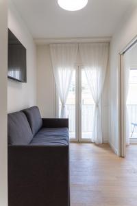 a living room with a couch and a large window at Palazzo Ambra in Soverato Marina