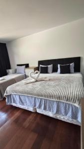 a bedroom with a large bed with blue and white sheets at Hospedagem Jardim Social,Quartos Econômicos e Suítes, Estacionamento Grátis in Curitiba +130 photos