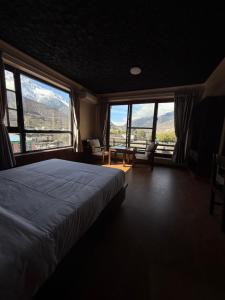 a bedroom with a bed and a view of mountains at Bön Valley in Jomsom