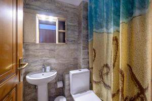 a bathroom with a toilet and a sink at Studios Efi beach in Vourvourou +53 photos