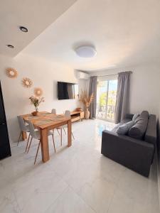 a living room with a table and a couch at Punta Prima Sun & Sea Apartament in Punta Prima