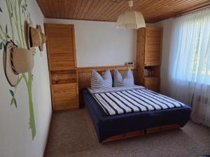 a bedroom with a bed with white pillows at Inselidyll in Karlshagen