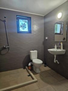 a bathroom with a toilet and a sink at Къща за гости Калабрия in Golden Sands +23 photos