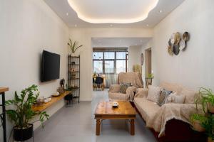 a living room with a couch and a table at Auster House Santorini in Kamari
