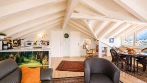 a living room with a table and a kitchen at Ferienwohnung Biechteler in Schwangau +15 photos