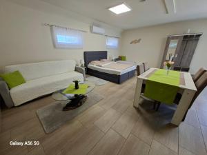 a living room with a couch and a table at Tölgyfa Vendégház in Kiskőrös +89 photos