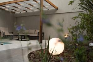 a patio with a couch and a table at VAYU LuxuryLofts in Bahía Blanca