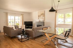 a living room with a couch and a table at Vila Bicuda Resort in Cascais