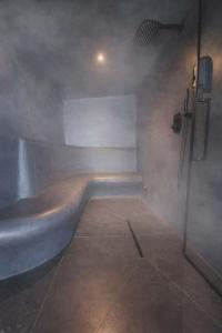 a bathroom with a tub and a shower at 3 Waters Spa - Private Spa with Jacuzzi, Sauna & Hammam in Winenne
