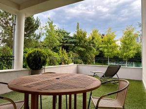 a wooden table and chairs on a balcony with a table at Villa Gdynia in Gdynia
