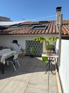 a patio with a table and chairs on a house at My Pradet in Le Pradet