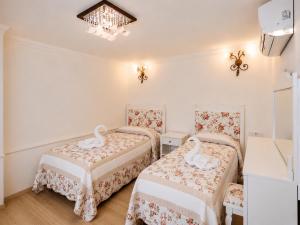 a room with two beds with swans on them at Oldtown Patio in Antalya