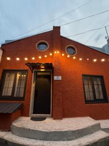 a red brick building with lights on it at Duplex Hause in Telavi