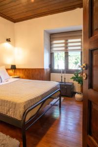 a bedroom with a bed and a window in it at Portaria Heritage House in Portaria