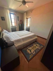 a bedroom with a bed and a rug at La Torretta in Barga