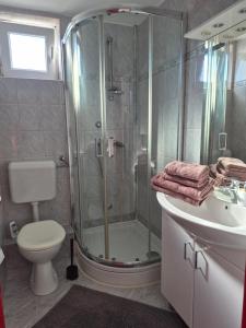 a bathroom with a shower and a toilet and a sink at Boutique Apartments Julija in Vodice +44 photos