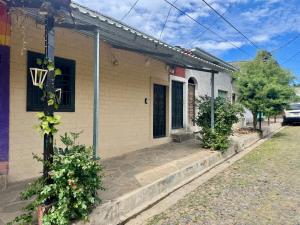 a house with a driveway in front of it at Alojamiento Blankyta in Ahuachapán