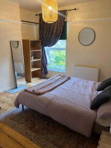 a bedroom with a large bed and a window at Mansfield House in Norwich