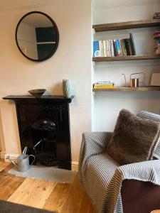 a living room with a couch and a mirror at Mansfield House in Norwich