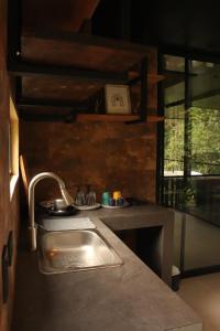 a kitchen with a sink and a counter top at Itawa ecoparque in Villavicencio +19 photos