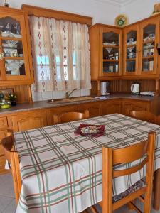 a kitchen with a table with a plaid table cloth on it at Emporios Blue Apartment in Emborios