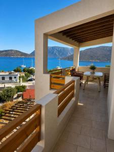 a balcony of a house with a view of the ocean at Emporios Blue Apartment in Emborios