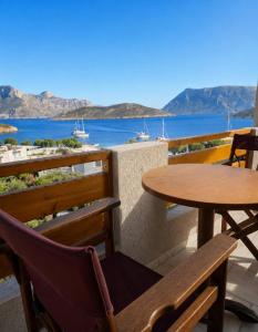 a patio with two tables and a view of the water at Emporios Blue Apartment in Emborios +6 photos