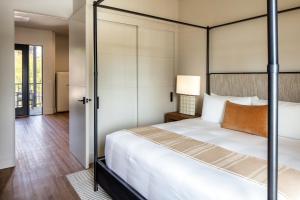 a bedroom with a four poster bed and a hallway at Duchamp Healdsburg in Healdsburg +23 photos