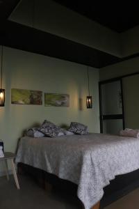 a bedroom with a bed with two pillows on it at Itawa ecoparque in Villavicencio