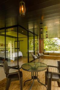 a room with a table and chairs and a bed at Itawa ecoparque in Villavicencio