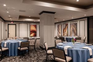 a banquet room with tables and chairs with blue tablecloths at Heathman Hotel in Portland