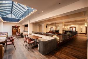 a restaurant with tables and chairs and a glass ceiling at Heathman Hotel in Portland