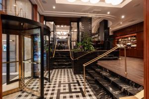 a lobby with a staircase in a building at Heathman Hotel in Portland