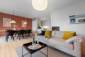 a living room with a couch and a table at 84286-Ebeltoft-Ndr-Strandvej-3-M in Ebeltoft