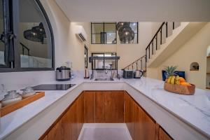 a kitchen with a sink and a counter with fruits at 2BR villa w - pool & beach access in Mengwi