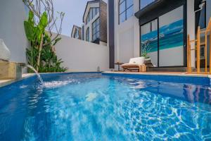 a swimming pool in the middle of a house at 2BR villa w - pool & beach access in Mengwi