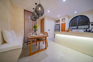 a living room with a table and a kitchen at 2BR villa w - pool & beach access in Mengwi +202 photos