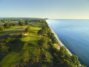 an aerial view of a golf course next to the water at Gladeholm - Kivik - artist studio in Kivik